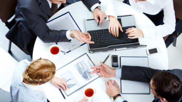 Image of business people hands working with papers and typing at meeting